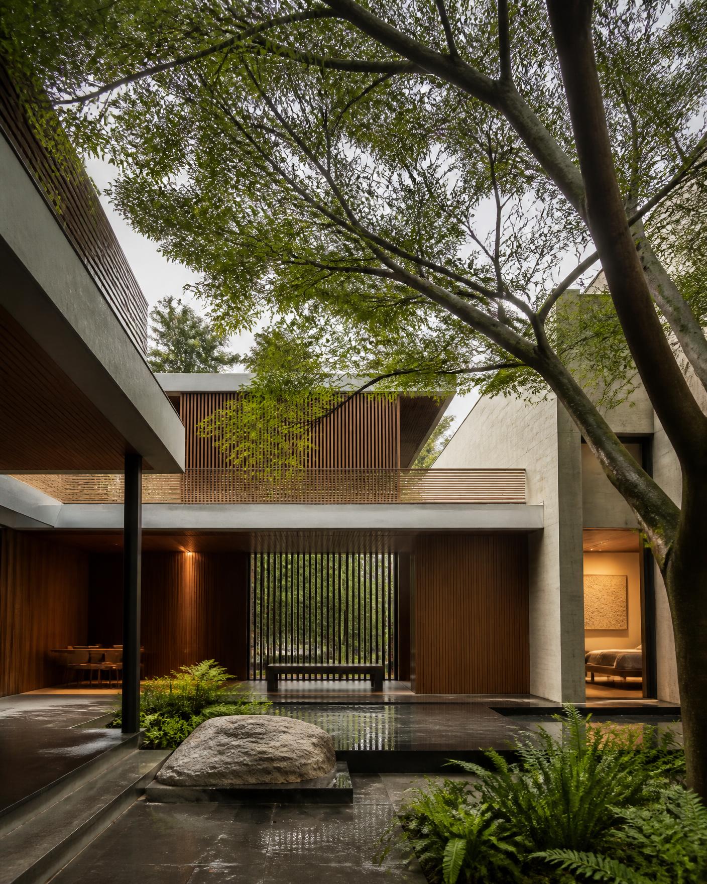 Contemporary Bangalore courtyard with stone and mature trees